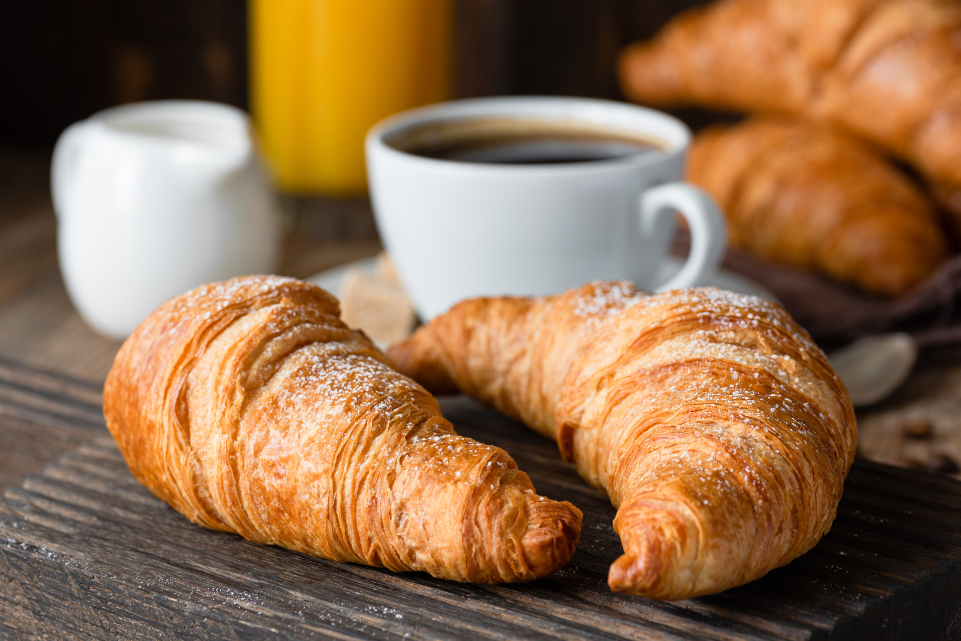 Fresh croissants served with a cup of coffee at a bakery cafe